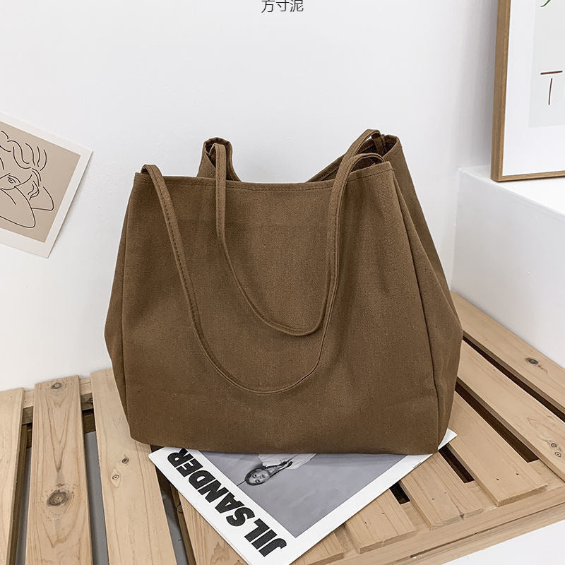 Japanese lazy style large capacity hand-held shoulder bag environmentally friendly shopping bag simple Korean version student literary canvas schoolbag