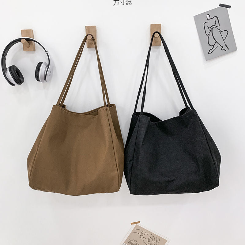 Japanese lazy style large capacity hand-held shoulder bag environmentally friendly shopping bag simple Korean version student literary canvas schoolbag