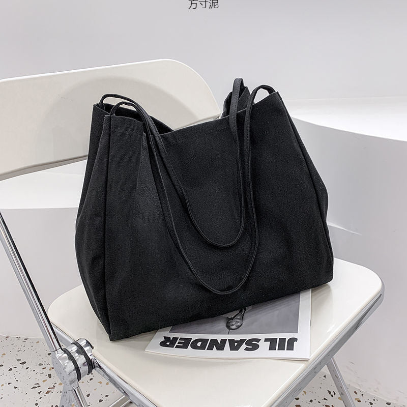 Japanese lazy style large capacity hand-held shoulder bag environmentally friendly shopping bag simple Korean version student literary canvas schoolbag