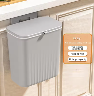 Gray wall-mounted trash can with text overlay on a kitchen cabinet background